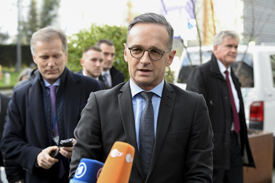 German Foreign Minister Heiko Maas, center, speaks with the media as he arrives to meet with Italian Foreign Minister Luigi Di Maio, French Foreign Minister Jean-Yves Le Drian, British Foreign Secretary Dominic Raab and European Union foreign policy chief Josep Borrell to discuss the situation in Libya at the EEAS building in Brussels, Tuesday, Jan. 7, 2020. The ministers will also hold talks later Tuesday which are expected to center on the situation in Iran and Iraq. (John Thys, Pool Photo via AP)