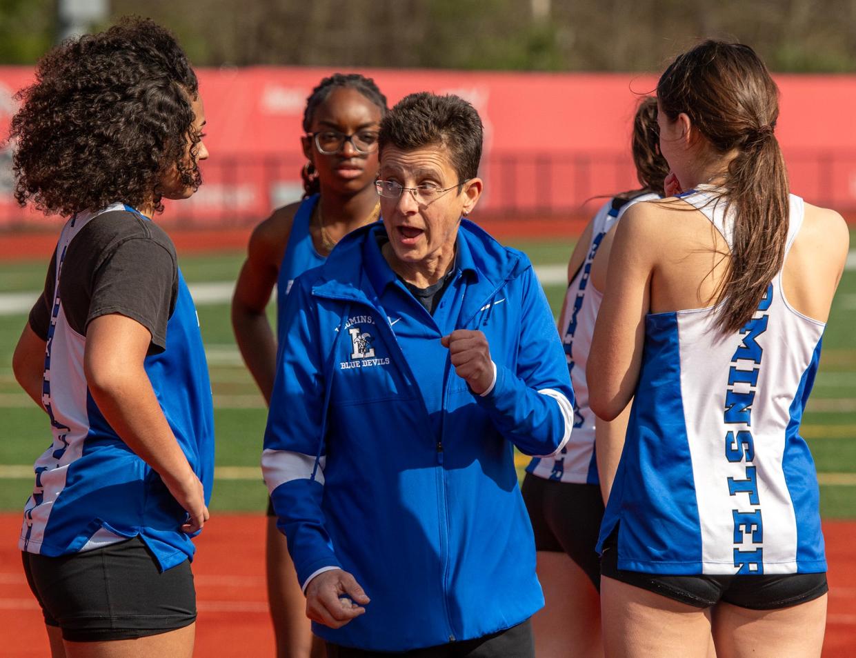 Leominster High School track & field coach Karen Marino works with high jumpers during a meet at North Middlesex Regional High School Wednesday.