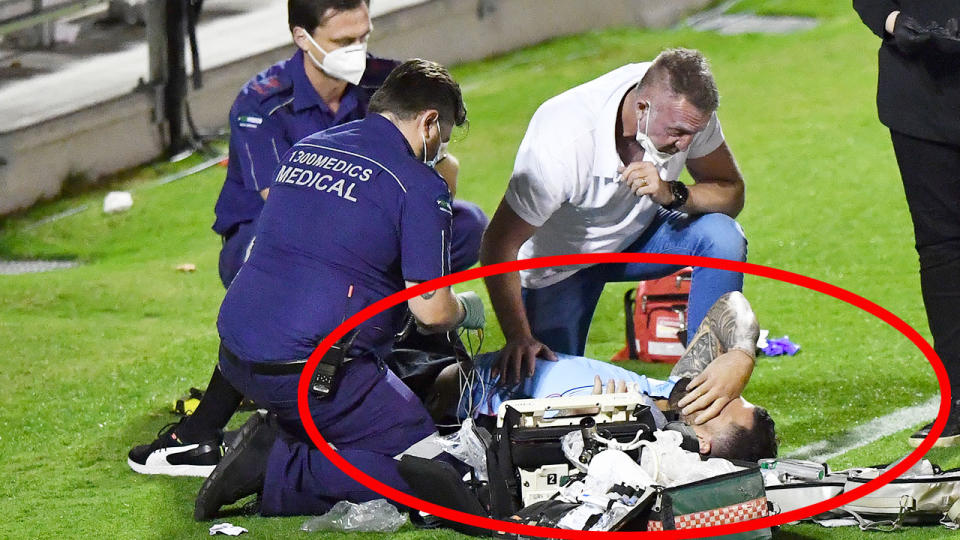 Pictured here, paramedics treat Andrew Fifita after the scary incident. 