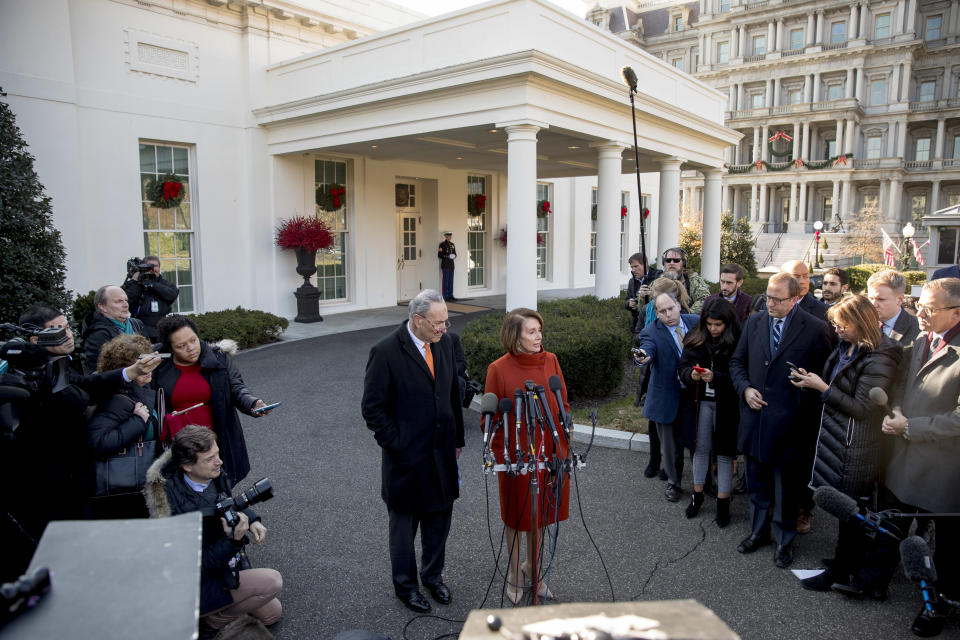 House Minority Leader Nancy Pelosi of Calif., right, accompanied by Senate Minority Leader Sen. Chuck Schumer of N.Y., left, speaks to members of the media outside the West Wing of the White House in Washington, Tuesday, Dec. 11, 2018, following a meeting with President Donald Trump. (AP Photo/Andrew Harnik)