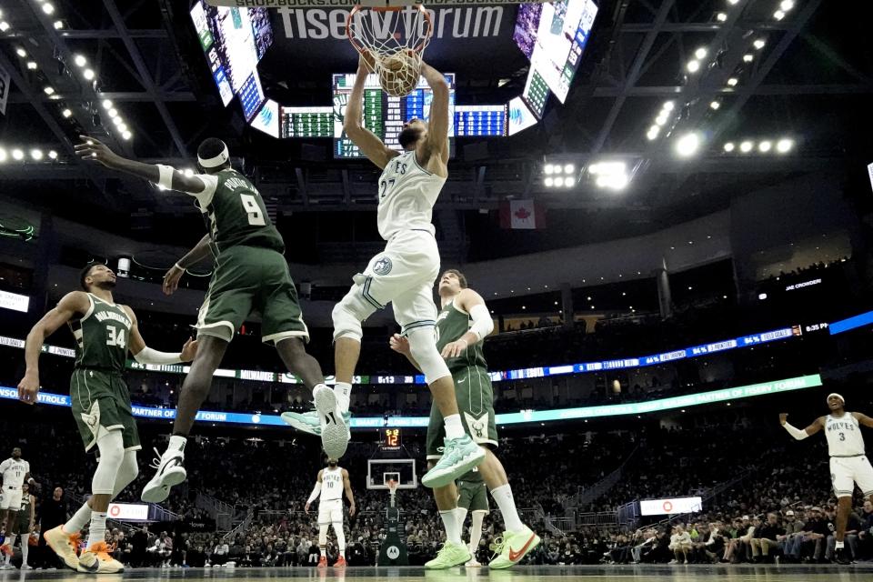 Minnesota Timberwolves' Rudy Gobert dunks past Milwaukee Bucks' Bobby Portis during the second half of an NBA basketball game Thursday, Feb. 8, 2024, in Milwaukee. (AP Photo/Morry Gash)