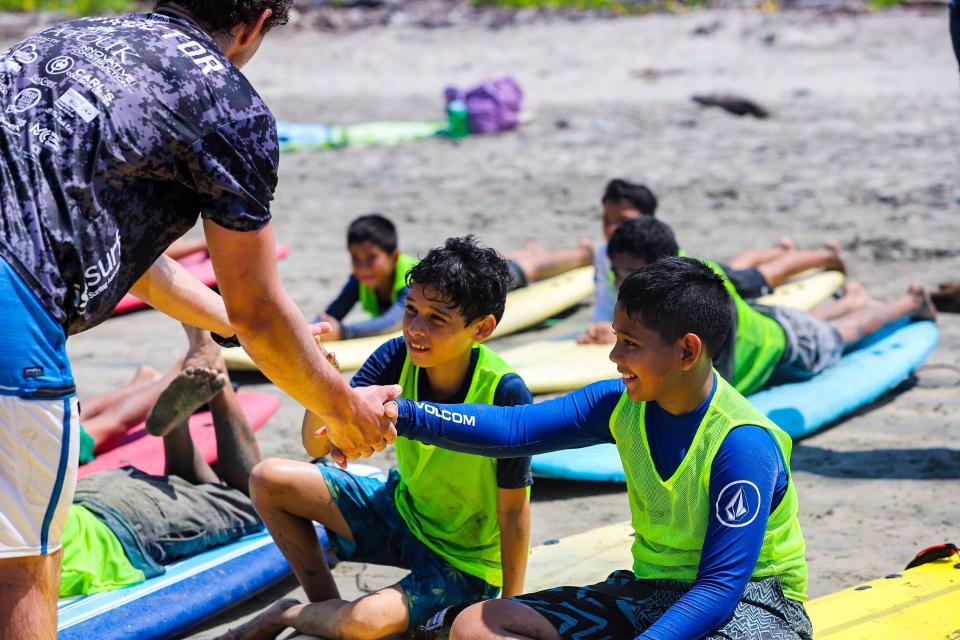 Surfers at Happy Camp, a new surf therapy camp in Costa Rica founded by a Fall River native.