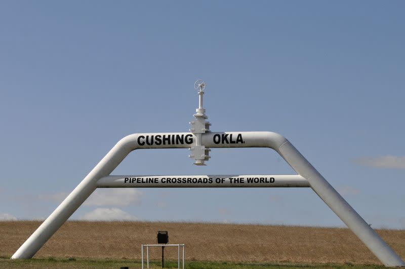 FILE PHOTO: A sign built out of a pipeline that reads "pipeline crossroads of the world" welcomes visitors to town in Cushing