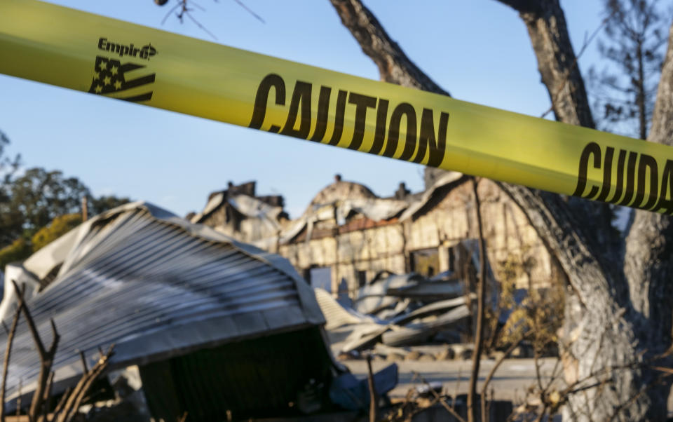 In this Tuesday, Nov. 5, 2019, photo, yellow tape from the Kincade Fire surrounds the old general store and post office built in 1869, that had become the main building for the Soda Rock Winery in Healdsburg, Calif. This Fountaingrove section of Santa Rosa in California's wine country was one of the neighborhoods turned to piles of ash and debris by the now infamous Tubbs Fire of 2017. It had been the most destructive wildfire in California history, until last year, when the Camp Fire ravaged the town of Paradise, to the north, killing 86 people. (AP Photo/Lacy Atkins)