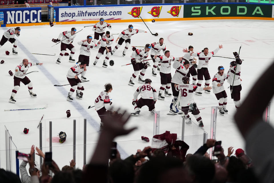 Latvia celebrates their game winning goal in overtime over the United States in their bronze medal match at the Ice Hockey World Championship in Tampere, Finland, Sunday, May 28, 2023. Latvia won 4-3. (AP Photo/Pavel Golovkin)