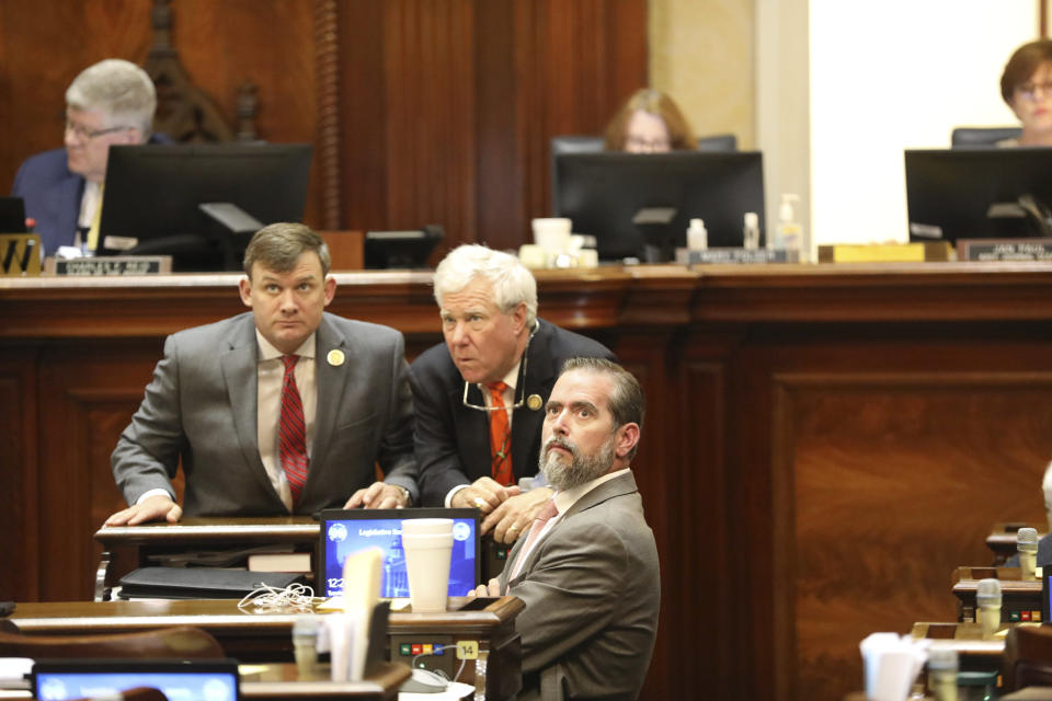 South Carolina Rep. Russell Ott, D-St. Matthews, left, Rep. Bill Hixon, R-North Augusta, center, and Rep. Cal Forrest, R-Monetta, right, talk before the House begins debating an abortion bill on Tuesday, May 16, 2023, in Columbia, South Carolina. (AP Photo/Jeffrey Collins)