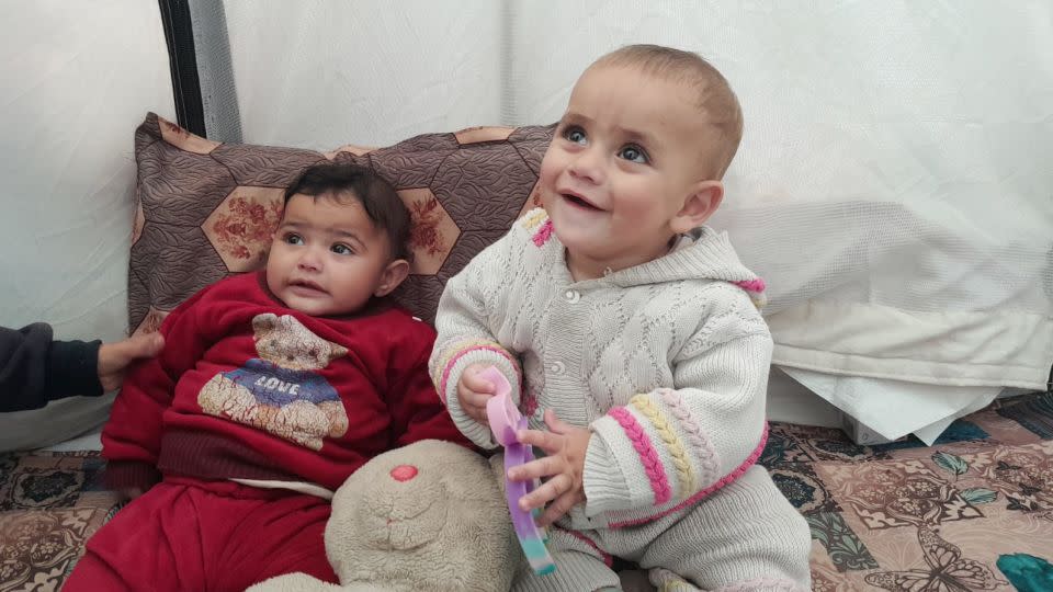 Infant orphans Hoor (left) and Kanan (right) shelter inside a tent in a displacement camp in Rafah, in southern Gaza, on January 25. Palestinian caregivers say the stress of being unable to protect children from strikes is exacerbated by their inability to provide enough food. - Courtesy Hazem Saeed Al-Naizi