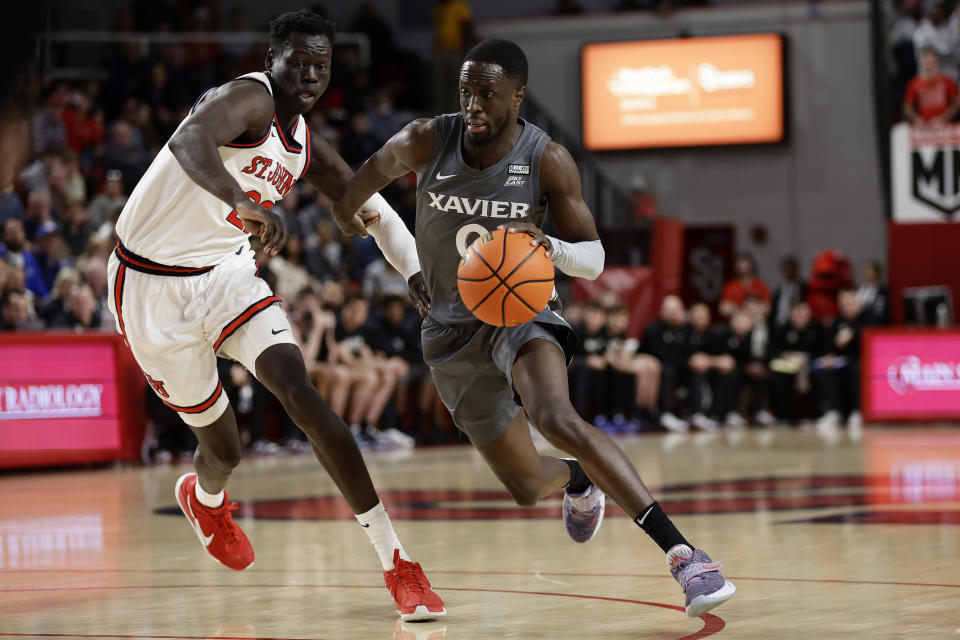 Xavier guard Souley Boum (0) drives to the basket past St. John's forward Esahia Nyiwe during the first half of an NCAA college basketball game Wednesday, Dec. 28, 2022, in New York. (AP Photo/Adam Hunger)