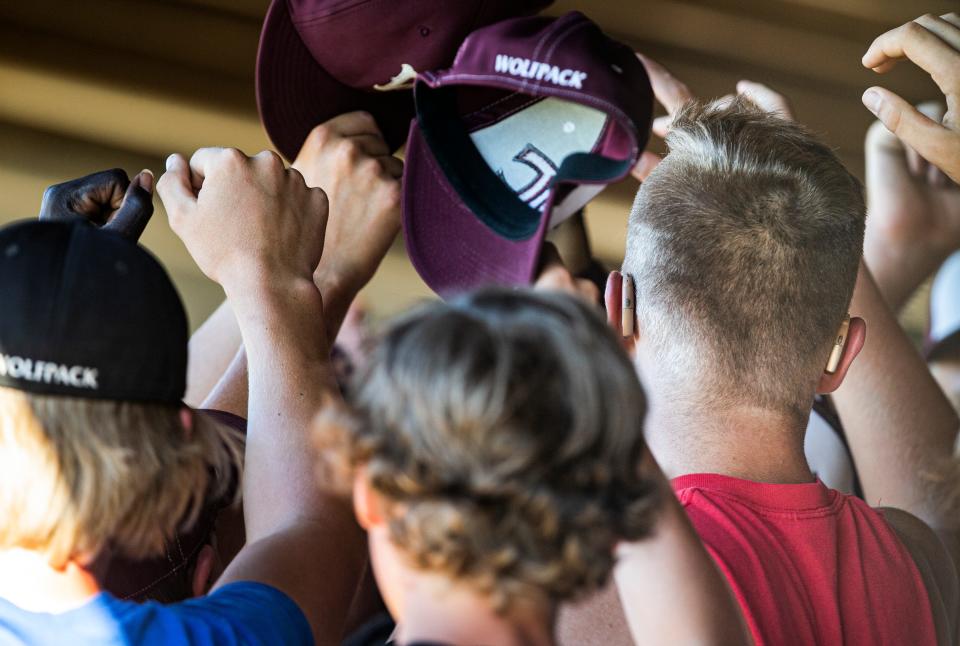 Western Christian senior Ty Van Essen, right, and teammates huddle up after practice at the high school on June 16 in Hull.