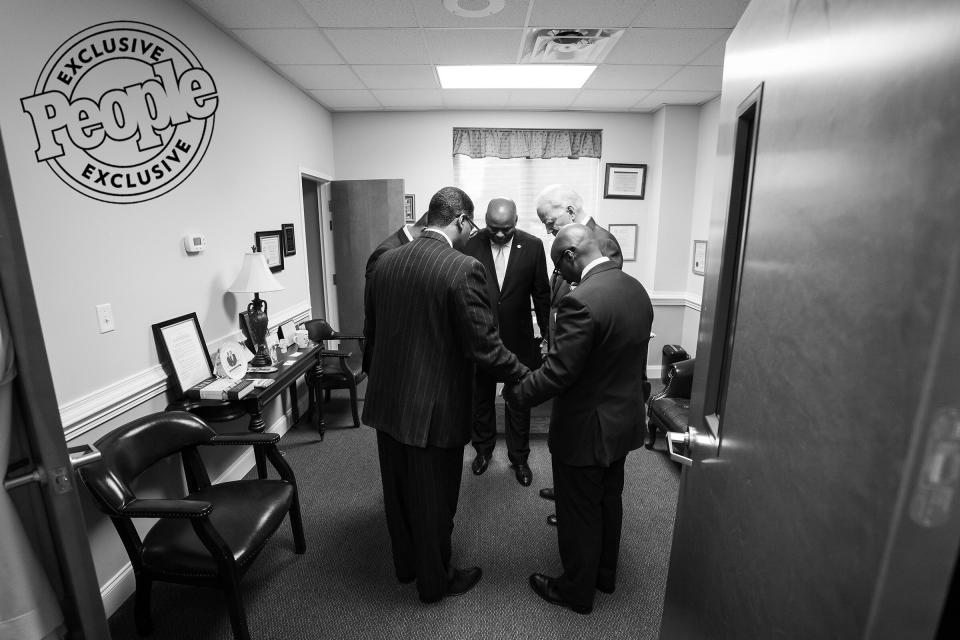 At Jerusalem Baptist Church's 150th Anniversary, Biden, state Sen. Gerald Malloy and Rev. Reginald S. Floyd take a moment to pray before going out to the Sunday service, in Hartsville, South Carolina, on Oct. 27, 2019.