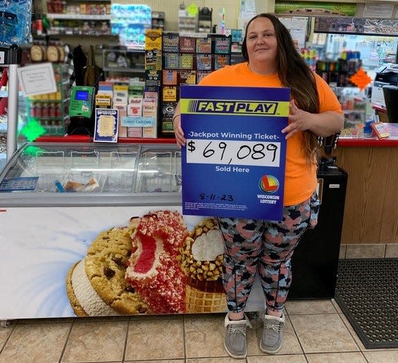 Amber Neal, the manager of Krist Food Mart, 916 E. Main St. in Suring, celebrates selling a jackpot-winning ticket in the Fast Play lottery game on Friday, Aug. 11, 2023.