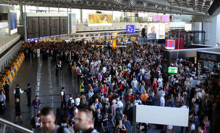 People gather at Frankfurt airport terminal after Terminal 1 departure hall was evacuated in Frankfurt, Germany, August 31, 2016. REUTERS/Alex Kraus