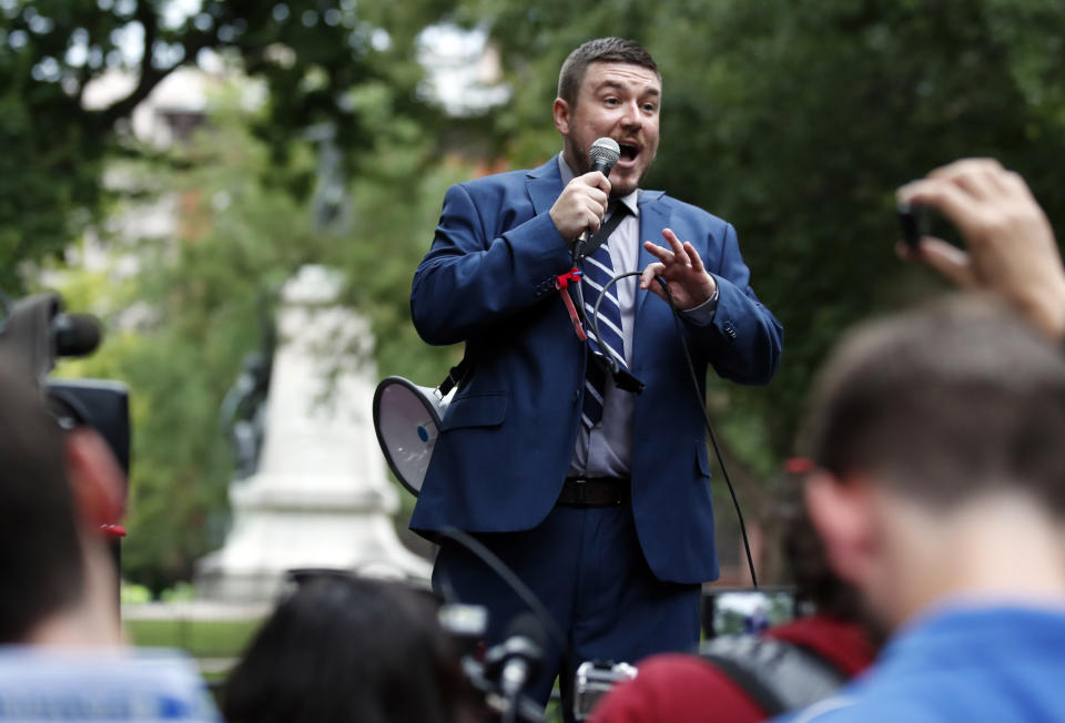 FILE - In this Aug. 12, 2018 file photo, White nationalist Jason Kessler speaks at a rally near the White House on the one year anniversary of the Charlottesville "Unite the Right" rally in Washington. A trial is beginning in Charlottesville, Virginia to determine whether white nationalists who planned the so-called “Unite the Right” rally will be held civilly responsible for the violence that erupted. (AP Photo/Alex Brandon, FILE)