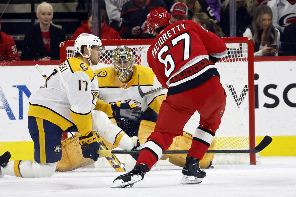 Carolina Hurricanes' Max Pacioretty (67) has his shot go off the hand of Nashville Predators center Mark Jankowski (17) in front of Predators goaltender Juuse Saros (74) during the first period of an NHL hockey game in Raleigh, N.C., Thursday, Jan. 5, 2023. (AP Photo/Karl B DeBlaker)