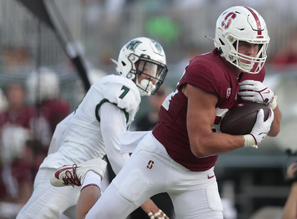 Stanford tight end Benjamin Yurosek makes a catch in front of Hawaii defensive back Meki Pei (7) during the first half of an NCAA college football game Friday, Sept. 1, 2023, in Honolulu. (Jamm Aquino/Honolulu Star-Advertiser via AP)