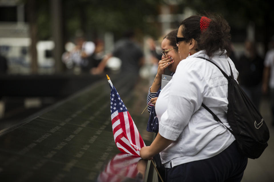 NEW YORK, NY - SEPTEMBER 11: A woman cries prior to the memorial observances held at the site of the World Trade Center on September 11, 2014 in New York City. This year marks the 13th anniversary of the September 11th terrorist attacks that killed nearly 3,000 people at the World Trade Center, Pentagon and on Flight 93. (Photo by Andrew Burton/Getty Images)