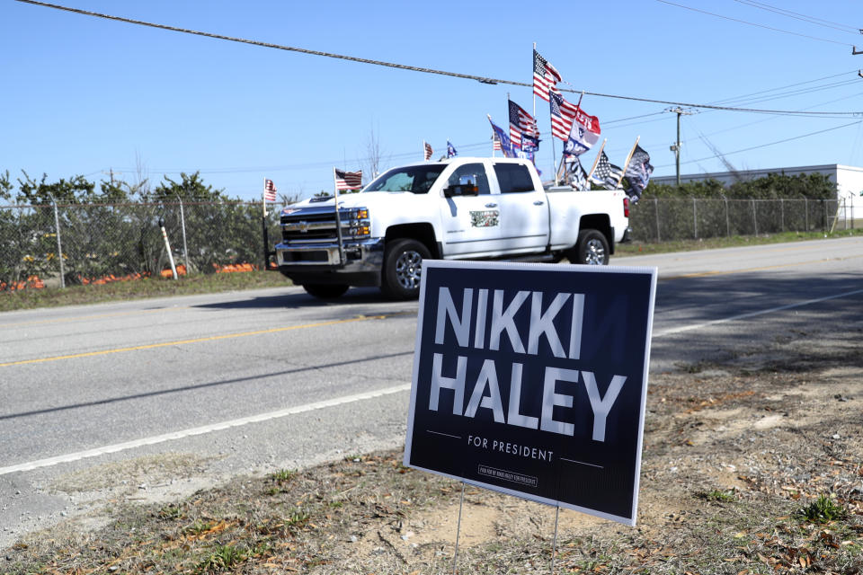 A supporter of Republican presidential candidate former President Donald Trump drives past Republican presidential candidate former UN Ambassador Nikki Haley's campaign event on Thursday, Feb.1, 2024, in Columbia, S.C. (AP Photo/Artie Walker Jr.)