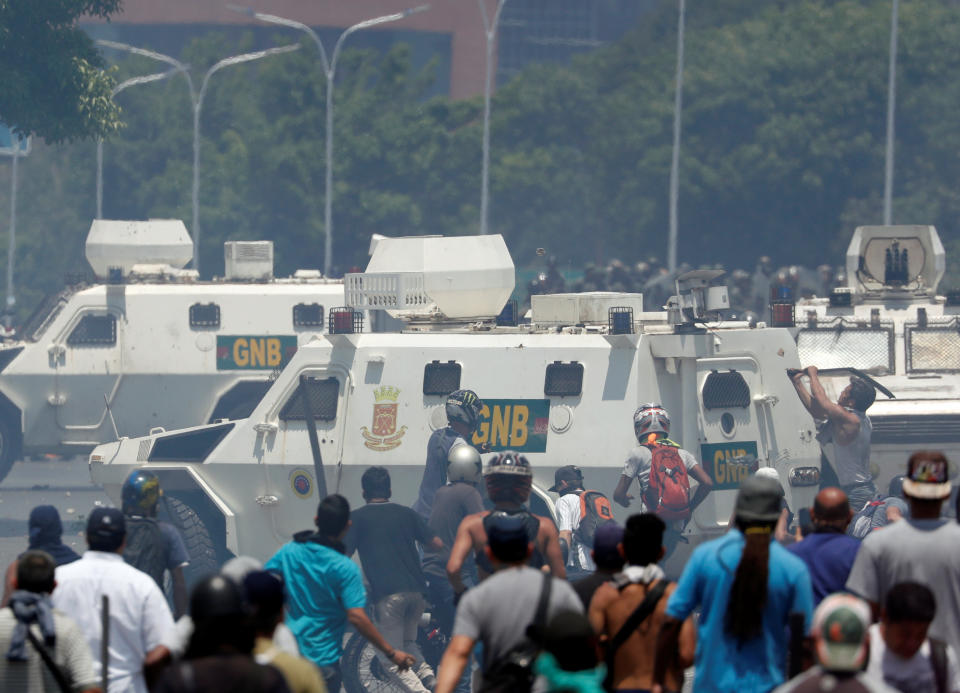 Opposition demonstrators clash with security forces near the Generalisimo Francisco de Miranda Airbase “La Carlota” in Caracas