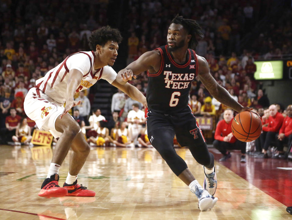 Texas Tech guard Joe Toussaint, right, moves the ball inside as Iowa State's Curtis Jones defends in the first half of an NCAA college basketball game, Saturday, Feb. 17, 2024, in Ames, Iowa. (AP Photo/Bryon Houlgrave)