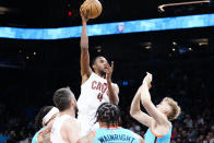 Cleveland Cavaliers' Evan Mobley (4) puts up a shot over Phoenix Suns' Jock Lansdale, right, during the first half of an NBA basketball game in Phoenix, Sunday, Jan. 8, 2023. (AP Photo/Darryl Webb)