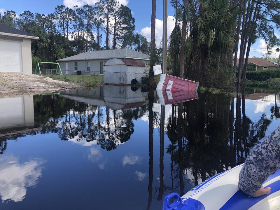 A portable toilet was seen on its side in Florida floodwaters after Hurricane Ian.  / Credit: Dave Tomasko