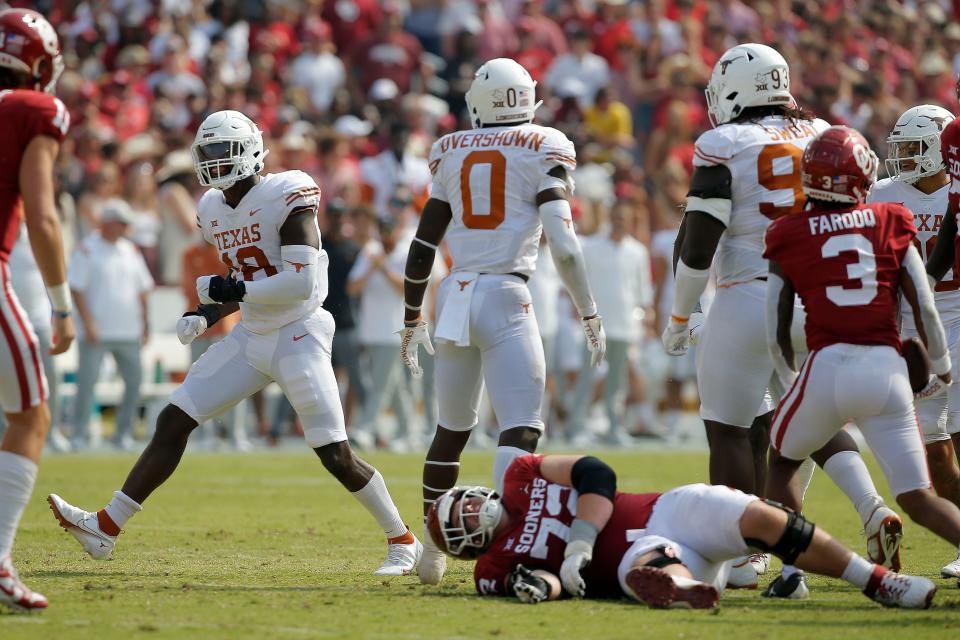 Texas Longhorns defensive end Ovie Oghoufo (18) celebrates after a play during the Red River Showdown college football game between the University of Oklahoma (OU) and Texas at the Cotton Bowl in Dallas, Saturday, Oct. 8, 2022. 