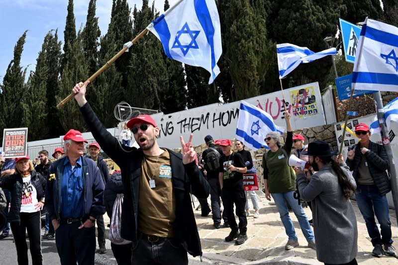 Army reserve activists wave Israeli flags on Tuesday in Jerusalem. The protest centered on the government's ongoing exemptions for military service for Orthodox members of the Jewish faith. Photo by Debbie Hill/UPI