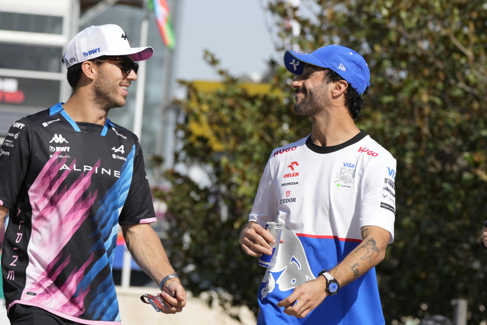 RB driver Daniel Ricciardo of Australia, right, and Alpine driver Pierre Gasly of France walk in the paddock at the Baku circuit, in Baku, Azerbaijan, Thursday, Sept.12, 2024. The Formula One Grand Prix will be held on Sunday. (AP Photo/Sergei Grits)