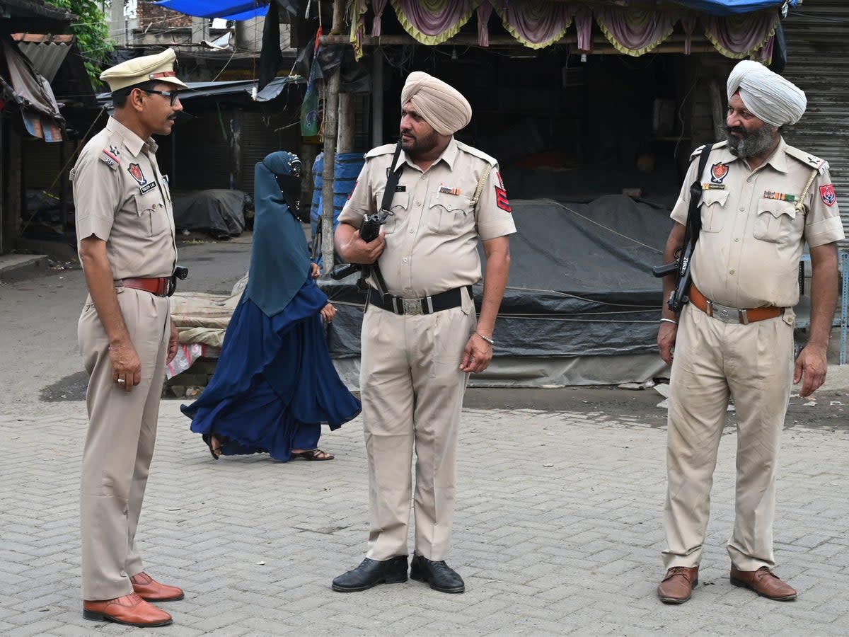 File. Police officers stand guard along a road on the outskirts of Kolkata on 12 July 2023 (AFP via Getty Images)