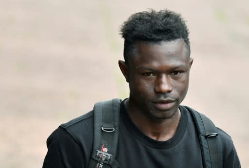 Malian migrant Mamoudou Gassama arriving to receive his temporary residence permit at the prefecture of Bobigny, northeast of Paris, on Tuesday