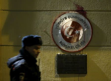 A policeman walks past a sign of the Turkish embassy stained by protesters in reaction after a Russian war plane was shot down by Turkey, in Moscow, Russia November 25, 2015. REUTERS/Sergei Karpukhin