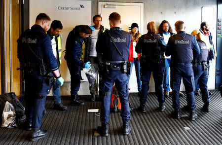 Swiss police officers arrest activists of environmental group Greenpeace after a protest against the financing of the Dakota-Access oil pipeline ahead of Swiss bank Credit Suisse's annual shareholder meeting in Zurich, Switzerland April 28, 2017. REUTERS/Arnd Wiegmann