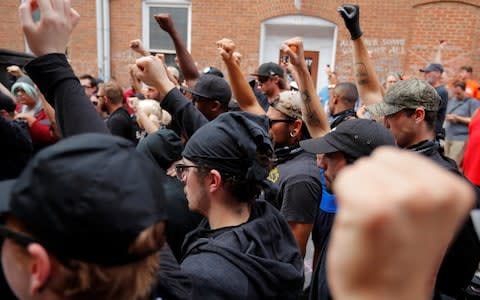 A group wearing anti-fascist labels visits the site where Heather Heyer was killed during the 2017 "Unite the Right" protests in Charlottesville - Credit: REUTERS/Brian Snyder