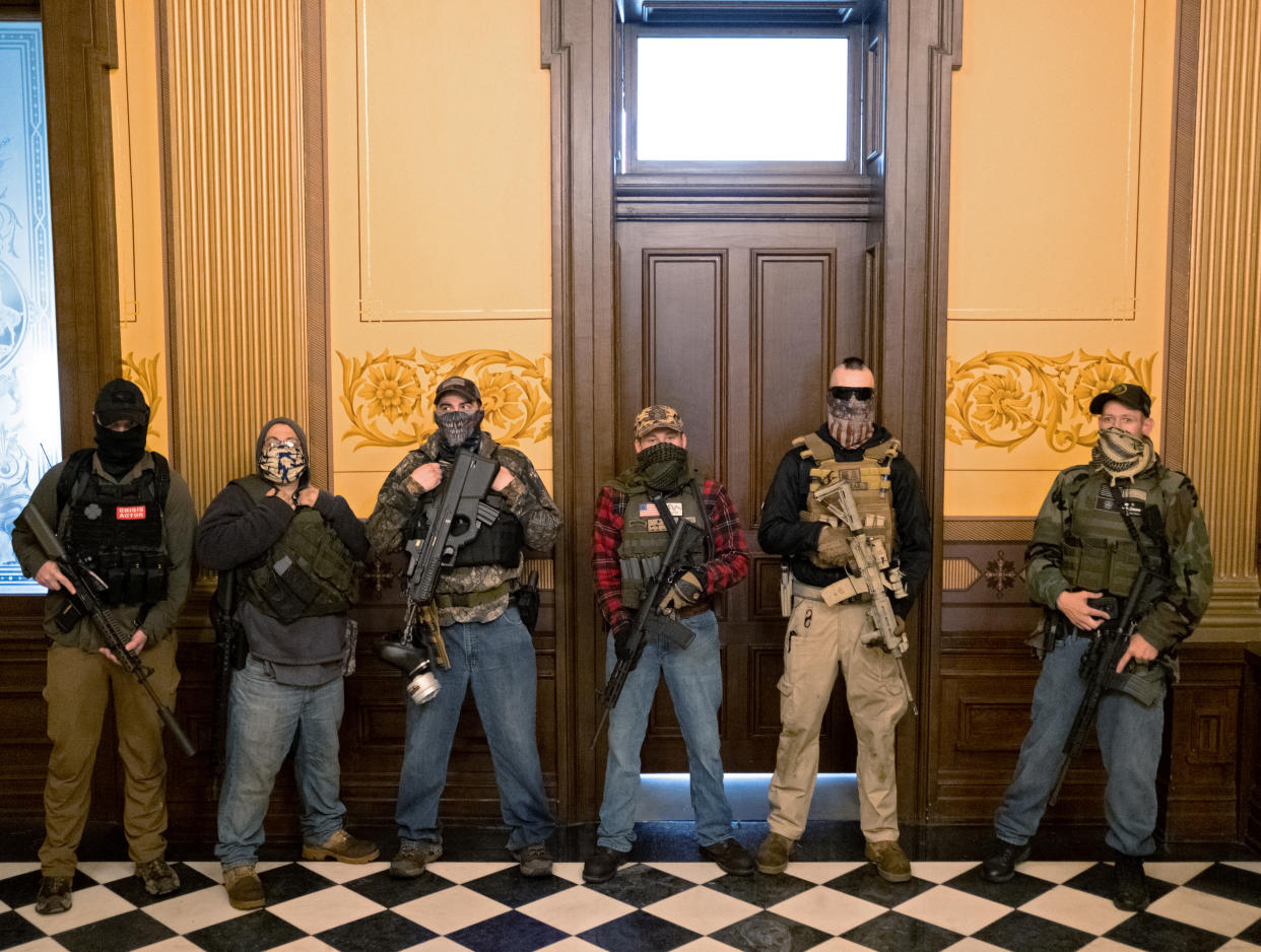 Armed protesters stand in front of Michigan Gov. Gretchen Whitmer's office at the state capitol in Lansing, April 30, 2020. (Seth Herald/Reuters)