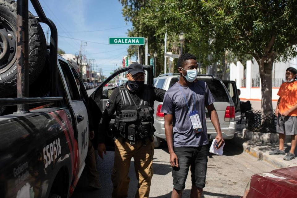 A migrant from Haiti is detained by Mexican immigration officers in Ciudad Acuña, Mexico, Wednesday, Sept. 22, 2021, near the U.S. border in Texas.