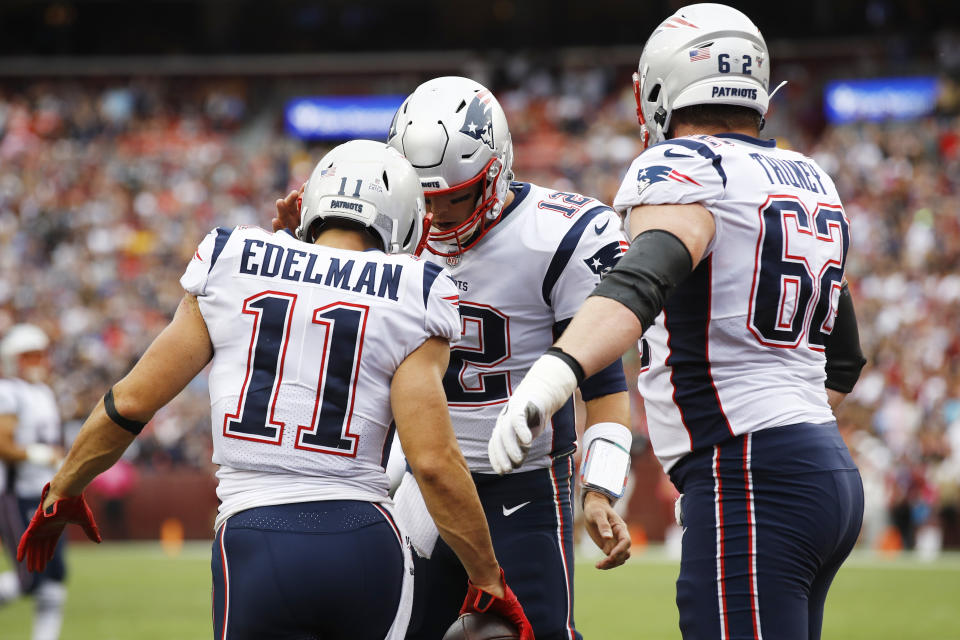 New England Patriots wide receiver Julian Edelman (11) celebrates his touchdown with New England Patriots quarterback Tom Brady (12) during the first half of an NFL football game, Sunday, Oct. 6, 2019, in Washington. (AP Photo/Patrick Semansky)