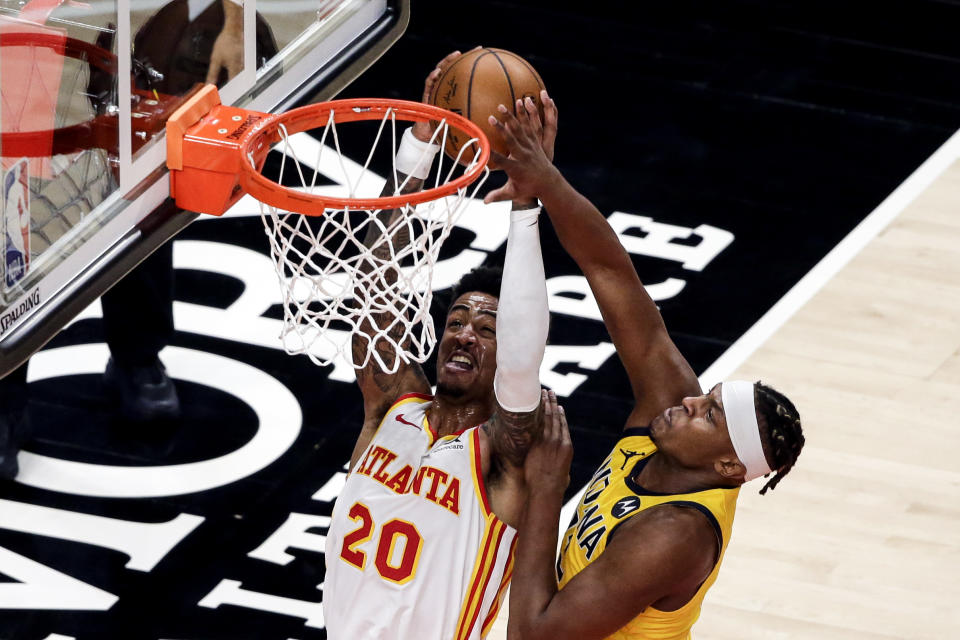 Indiana Pacers center Myles Turner (33) blocks a shot by Atlanta Hawks forward John Collins (20) during the second quarter of an NBA basketball game Saturday, Feb. 13, 2021, in Atlanta. (AP Photo/Butch Dill)