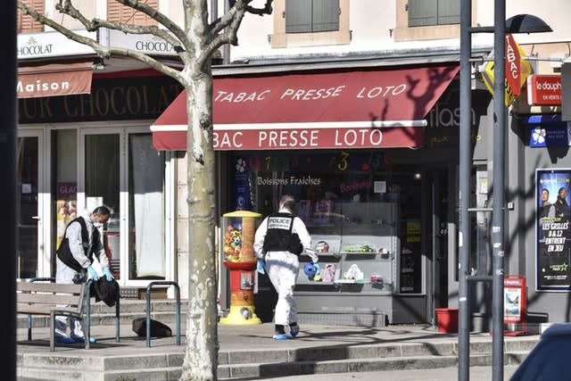 Police officers investigate after a man wielding a knife attacked residents venturing out to shop under lockdown  in Romans-sur-Isere, southern France