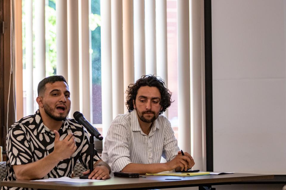 Providence City Councilor Miguel Sanchez, left, advocates for the change to multifamily zoning in his district during a June 18 hearing on the city's comprehensive plan. City Council staffer Miguel Youngs is at right.