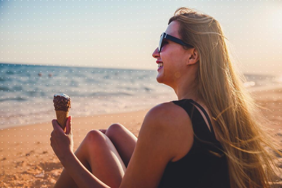 woman eating ice cream on the beach