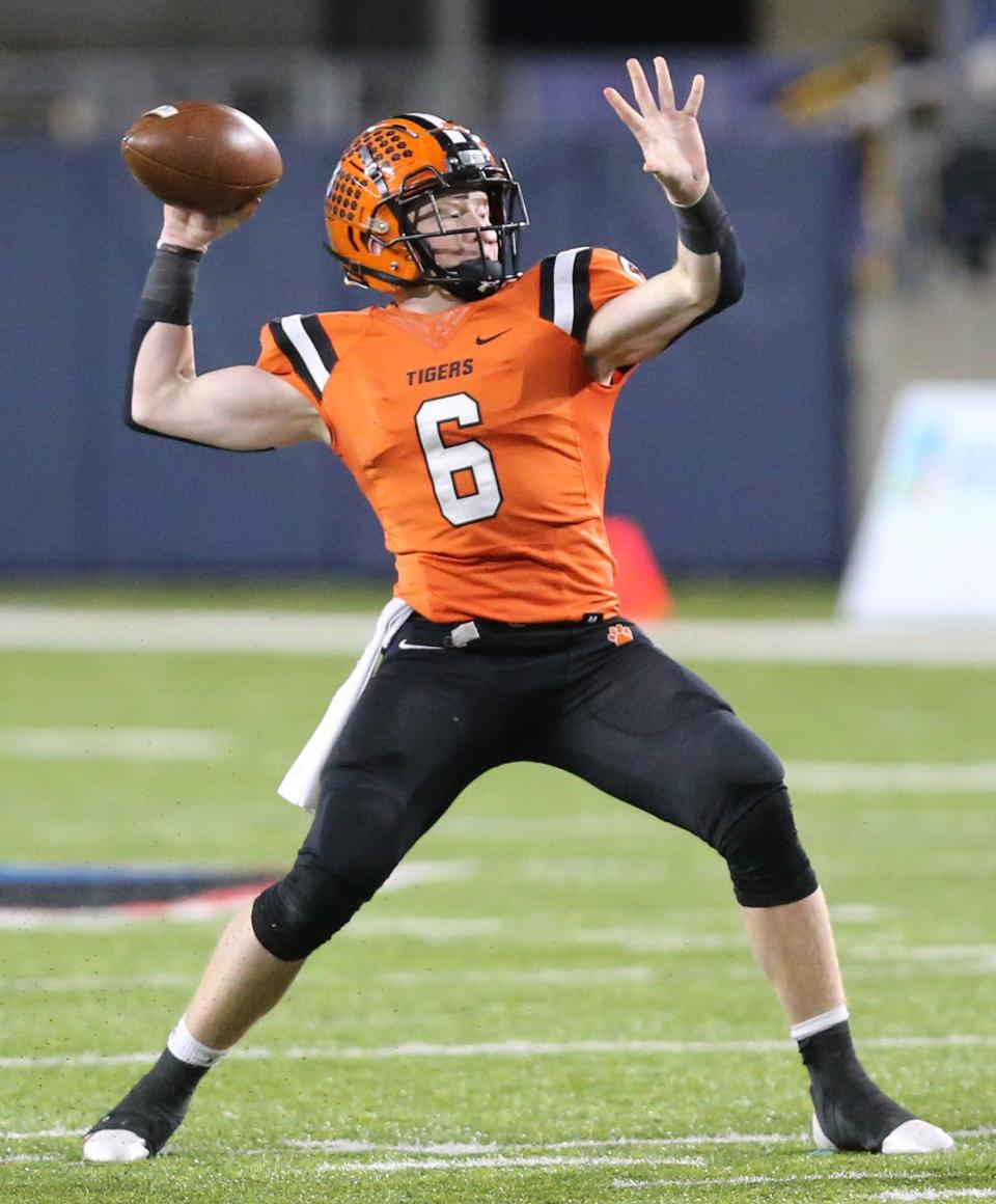 Versailles quarterback Carson Bey gets set to throw vs. Kirtland in the Division V state championship game at Tom Benson Hall of Fame Stadium on Saturday, Dec. 4, 2021.