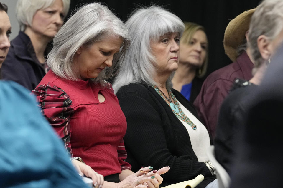 Kathy Smith, left, formerly Kathy Biggs, a former girlfriend of and victim of Scott Eizember, and Kim Evans, right, listen during clemency proceedings for convicted murderer and death row inmate Scott Eizember, Wednesday, Dec. 7, 2022, in Oklahoma City. (AP Photo/Sue Ogrocki)