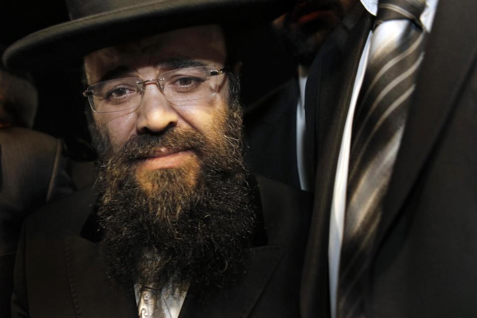 In a Sunday July 1, 2012 photo, Rabbi Yaakov Israel Ifargan, known as the 'X-Ray' rabbi for the belief he has the ability to diagnose patients by eyesight only, looks on during the annual gathering of the rabbi's followers and supporters in the town of Netivot, southern Israel. Over the past few decades, Ifargan and dozens of other rabbis have carefully positioned themselves at the fulcrum of Israeli power and influence. (AP Photo/Tsafrir Abayov)