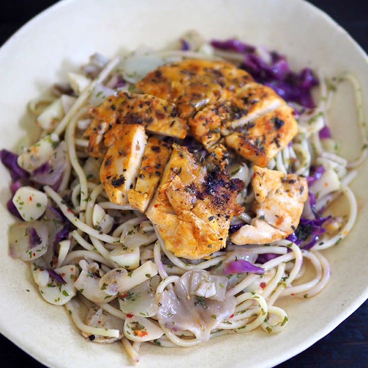 The pasta aglio olio topped with a grilled chicken breast has 'al dente' pasta with lots of garlic and onions