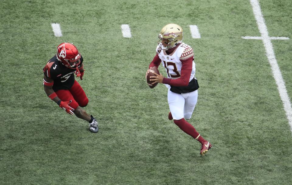 LOUISVILLE, KENTUCKY - OCTOBER 24:   Jordan Travis #13 of the Florida State Seminoles runs with the ball against the Louisville Cardinals at Cardinal Stadium on October 24, 2020 in Louisville, Kentucky. (Photo by Andy Lyons/Getty Images)