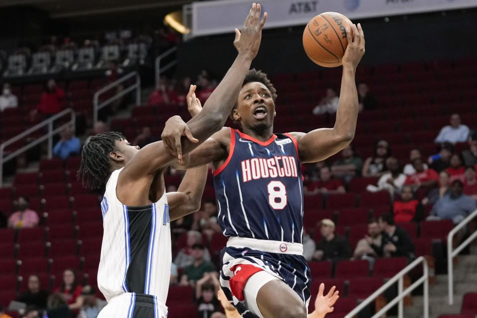 Houston Rockets forward Jae'Sean Tate (8) drives to the basket as Orlando Magic center Mo Bamba defends during the first half of an NBA basketball game Friday, Dec. 3, 2021, in Houston. (AP Photo/Eric Christian Smith)