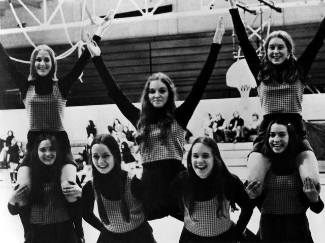 <p>Michael Ochs Archives/Getty</p> Madonna (center) practices with the freshman cheerleaders at Adams High School in 1972