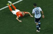 Arjen Robben of the Netherlands falls in front of Argentina's Martin Demichelis (R) during their 2014 World Cup semi-finals at the Corinthians arena in Sao Paulo July 9, 2014. REUTERS/Fabrizio Bensch (BRAZIL - Tags: SOCCER SPORT WORLD CUP)