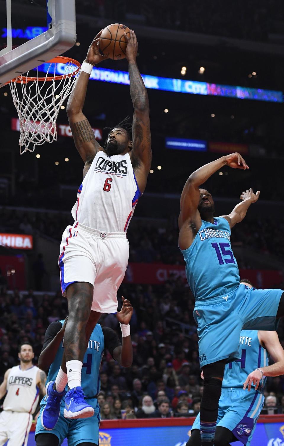 Los Angeles Clippers center DeAndre Jordan, left, dunks as Charlotte Hornets guard Kemba Walker defends during the first half of an NBA basketball game, Sunday, Feb. 26, 2017, in Los Angeles. (AP Photo/Mark J. Terrill)