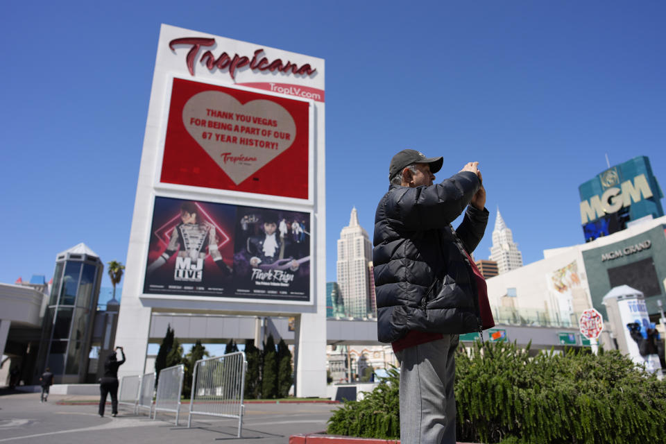 People take pictures before the closing of the Tropicana hotel-casino, Tuesday, April 2, 2024, in Las Vegas. The hotel-casino is slated for demolition in October to make room for a $1.5 billion baseball stadium. (AP Photo/John Locher)